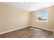 Bedroom with wood flooring, neutral walls, and a window at 1603 S Flanders Way, Aurora, CO 80017
