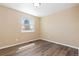 Bedroom featuring wood flooring, neutral walls, and a window at 1603 S Flanders Way, Aurora, CO 80017