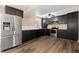 Spacious kitchen equipped with stainless steel appliances, dark cabinets, and granite countertops at 1603 S Flanders Way, Aurora, CO 80017