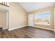 Well-lit room showcasing hardwood flooring, a large window, and neutral walls at 1603 S Flanders Way, Aurora, CO 80017