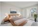 Bright main bedroom featuring a sliding glass door and stylish decor at 6705 S Field St # 803, Littleton, CO 80128
