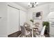 Cozy dining area featuring a round table, chandelier, and closet space at 6705 S Field St # 803, Littleton, CO 80128