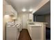 Galley kitchen with white cabinets and appliances at 6705 S Field St # 803, Littleton, CO 80128