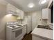 Well-lit kitchen with white appliances and cabinets at 6705 S Field St # 803, Littleton, CO 80128