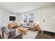 Bright living room with modern decor, wood floors, and large windows at 6705 S Field St # 803, Littleton, CO 80128