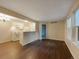 Bright living room with white kitchen view and hardwood flooring at 6705 S Field St # 803, Littleton, CO 80128