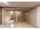 Unfinished basement area with painted walls and tile flooring at 2863 S Biscay Ct, Aurora, CO 80013