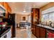 Kitchen area featuring updated appliances, wooden cabinets, and a breakfast nook at 2863 S Biscay Ct, Aurora, CO 80013