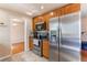 Cozy kitchen with stainless steel appliances, warm wood cabinets, and tiled floor at 2863 S Biscay Ct, Aurora, CO 80013