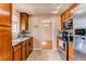 Kitchen with wooden cabinetry and stainless steel appliances at 2863 S Biscay Ct, Aurora, CO 80013