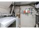 Functional laundry room with washer, dryer, and built in shelving for storage at 2863 S Biscay Ct, Aurora, CO 80013