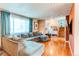 Cozy living room with natural light, wood floors, and a large sectional sofa at 2863 S Biscay Ct, Aurora, CO 80013