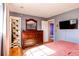 Main bedroom with wood flooring, dresser, and doorway to bathroom at 2863 S Biscay Ct, Aurora, CO 80013