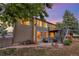 Back exterior view with a wood paneled house, outdoor hot tub and wood pile at 17166 Yellow Rose Way, Parker, CO 80134