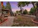 A fenced backyard offers space for leisure with a hot tub, a fire pit and small garden areas at 17166 Yellow Rose Way, Parker, CO 80134