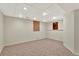 Finished basement area offers versatile space with carpet and recessed lighting at 17166 Yellow Rose Way, Parker, CO 80134
