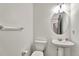 Clean, bright bathroom with white fixtures and pedestal sink offers a tidy and functional space at 17166 Yellow Rose Way, Parker, CO 80134