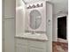 Functional bathroom with granite vanity, decorative mirror, and tile flooring is well-maintained at 17166 Yellow Rose Way, Parker, CO 80134