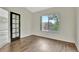Bedroom with dark wood flooring, vaulted ceilings, a large window, and a closet with glass doors at 17166 Yellow Rose Way, Parker, CO 80134