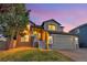Charming two-story home with an attached two-car garage, lush lawn, and welcoming front porch at 17166 Yellow Rose Way, Parker, CO 80134