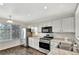 Modern kitchen featuring stainless steel appliances, white cabinets, and an undermounted stainless steel sink at 17166 Yellow Rose Way, Parker, CO 80134