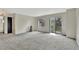 Bright living room with sliding glass doors and neutral carpet provides a comfortable living space at 17166 Yellow Rose Way, Parker, CO 80134