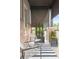 Cozy balcony featuring stylish seating, black and white rug, and decorative plants in sleek containers at 6485 E Cedar Ave, Denver, CO 80224