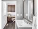 Bathroom featuring white sink, dark cabinets, and view to an office area through the doorway at 6485 E Cedar Ave, Denver, CO 80224