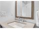 Bathroom featuring a vanity with sink, a large mirror, and modern fixtures at 6485 E Cedar Ave, Denver, CO 80224