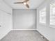 Minimalist bedroom with neutral carpet, fan, and ample natural light at 6485 E Cedar Ave, Denver, CO 80224
