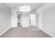 Spacious and brightly lit bedroom featuring neutral colors and multiple doorways at 6485 E Cedar Ave, Denver, CO 80224