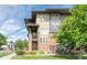 Exterior view of home featuring brick and siding, complemented by lush greenery and landscaping at 6485 E Cedar Ave, Denver, CO 80224