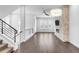 Open-concept living room with wood floors, electric fireplace, and large windows at 6485 E Cedar Ave, Denver, CO 80224