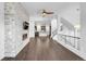 Spacious living room with stone accent wall, modern fireplace, and beautiful hardwood floors at 6485 E Cedar Ave, Denver, CO 80224