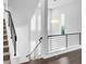 Modern staircase with sleek metal railings, white walls, and contemporary lighting at 6485 E Cedar Ave, Denver, CO 80224
