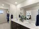 Modern bathroom featuring double sinks, contemporary decor, and ample counter space at 20802 E 66Th Ave, Aurora, CO 80019