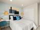 Bedroom with white bedding, woven pendant lights, accent wall hanging, desk, chair, and a closet with sliding doors at 20802 E 66Th Ave, Aurora, CO 80019