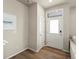 Bright entryway featuring hardwood floors and a modern white front door at 20802 E 66Th Ave, Aurora, CO 80019