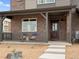 Charming covered front porch with seating area, perfect for relaxing outdoors at 20802 E 66Th Ave, Aurora, CO 80019