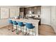 Kitchen island featuring granite counters, stainless appliances, and breakfast bar at 20802 E 66Th Ave, Aurora, CO 80019
