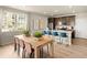 Bright kitchen with a large window, island with seating, and stainless appliances at 20802 E 66Th Ave, Aurora, CO 80019