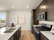 View of open kitchen with granite counters, stainless appliances and view outside at 20802 E 66Th Ave, Aurora, CO 80019