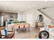 Open-concept living room and kitchen with modern design, wood floors, and stairs at 20802 E 66Th Ave, Aurora, CO 80019