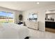 A serene main bedroom with a view, neutral tones, and an attached bathroom at 20802 E 66Th Ave, Aurora, CO 80019