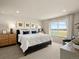 Bright main bedroom featuring a luxurious bed, neutral colors, and a scenic view from the large window at 20802 E 66Th Ave, Aurora, CO 80019