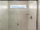 Sleek shower featuring tiled walls, modern fixtures, and a window for natural light at 20802 E 66Th Ave, Aurora, CO 80019