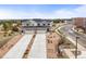 An aerial view of attached homes with two-car garages, desert landscaping and nearby open land at 650 Bishop Pine Way, Castle Rock, CO 80104