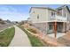 Townhome exterior with manicured landscaping, a sidewalk, and private balcony is perfect for relaxing at 650 Bishop Pine Way, Castle Rock, CO 80104