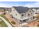 Beautiful exterior with stone accents, gray siding, a second story balcony, and professional landscaping at 650 Bishop Pine Way, Castle Rock, CO 80104