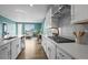 Bright, updated kitchen with white cabinets, subway tile backsplash, and stainless steel appliances at 650 Bishop Pine Way, Castle Rock, CO 80104